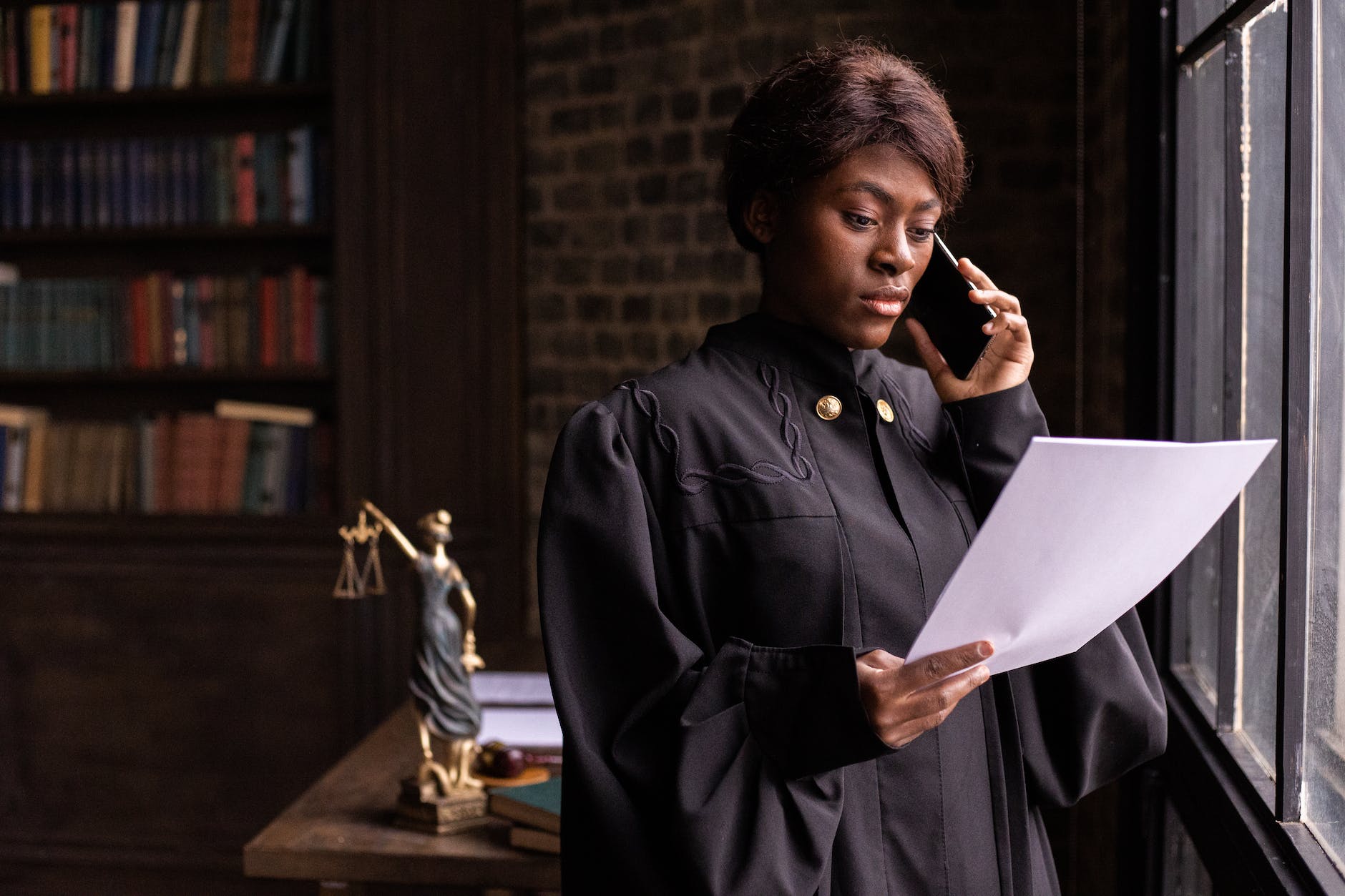 a judge reading a document while having a phone call